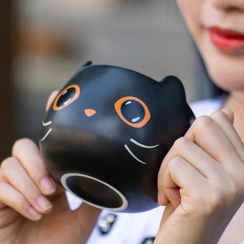 Black ceramic cat-shaped mug with pumpkin spoon couple design, 355ml capacity.