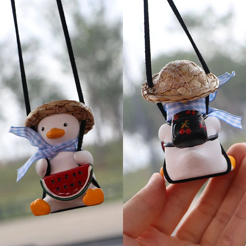 Swing Duck Car Pendant hanging from a rearview mirror, showcasing vibrant colors and unique design