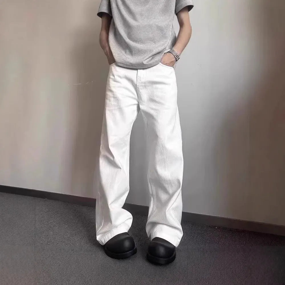 Men's white straight-leg cotton denim jeans on a hanger, showing the mid waist and wide leg opening.
