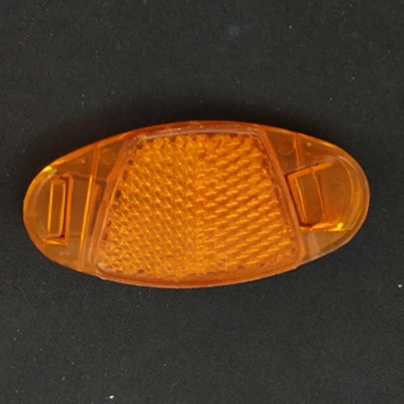 White and yellow plastic bicycle spoke reflector for wheel safety, dimensions 7.2cm long by 3.5cm wide.