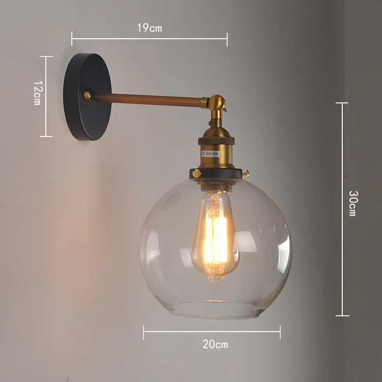 Round retro glass ball wall lamp in amber, smoke grey, or transparent finish with aluminium holder.