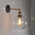 Round retro glass ball wall lamp in amber, smoke grey, or transparent finish with aluminium holder.