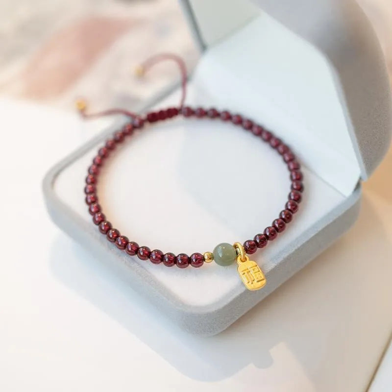 Hand-woven red rope bracelet with strawberry quartz and garnet beads for women