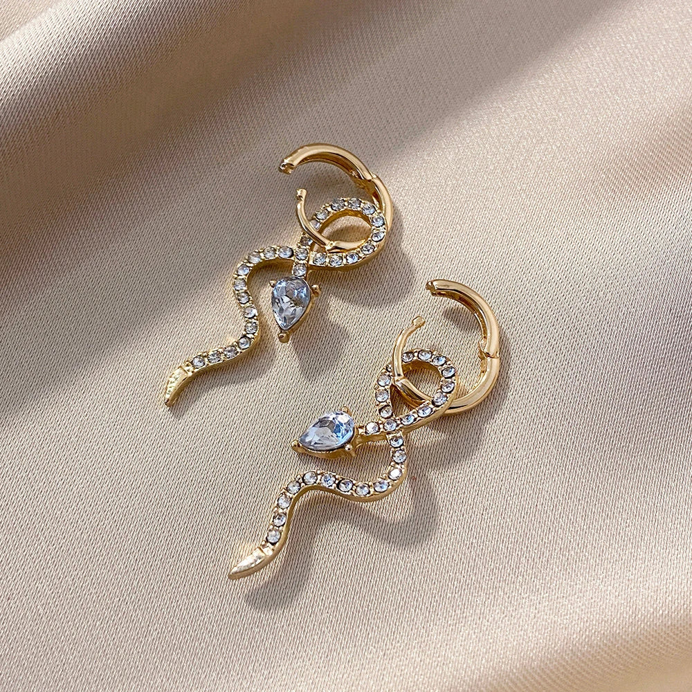 Elegant snake-shaped dangle earrings with a golden hue, showcasing a blend of European and American style