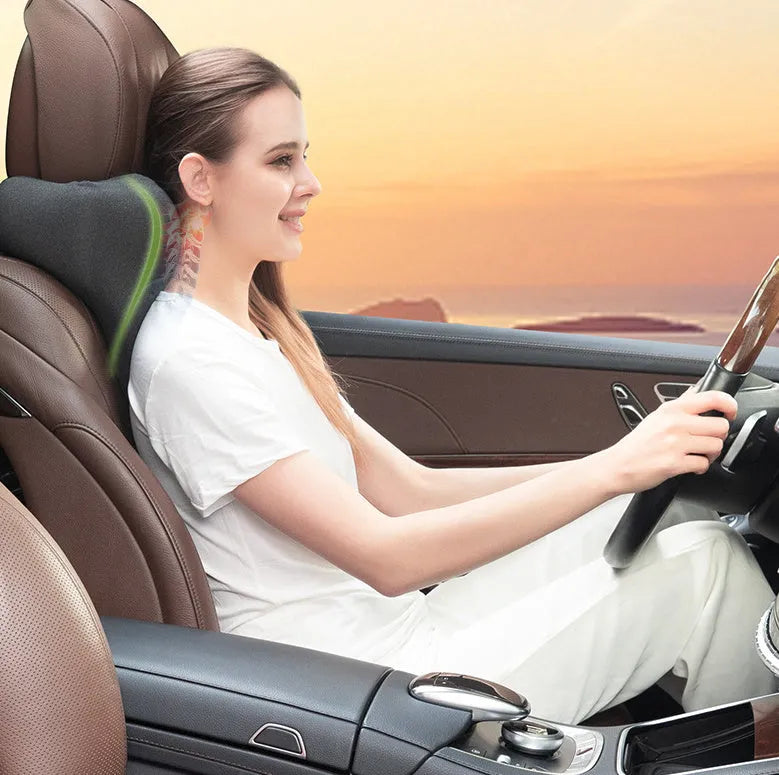 Dark gray memory foam car neck pillow on a car headrest.