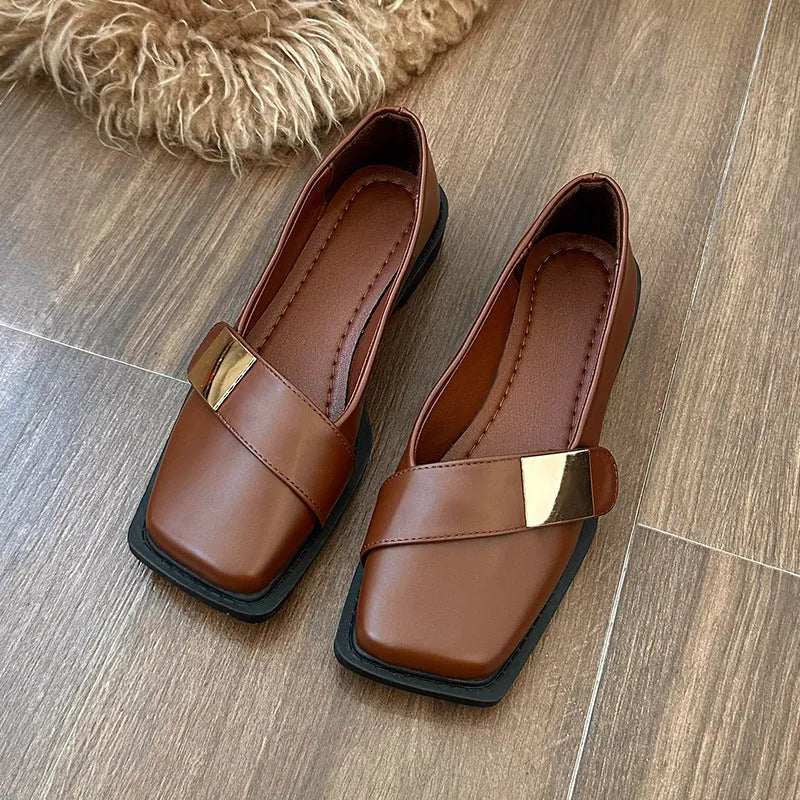 Beige women's square toe flat slip-on shoes with a metal buckle and low square heel.