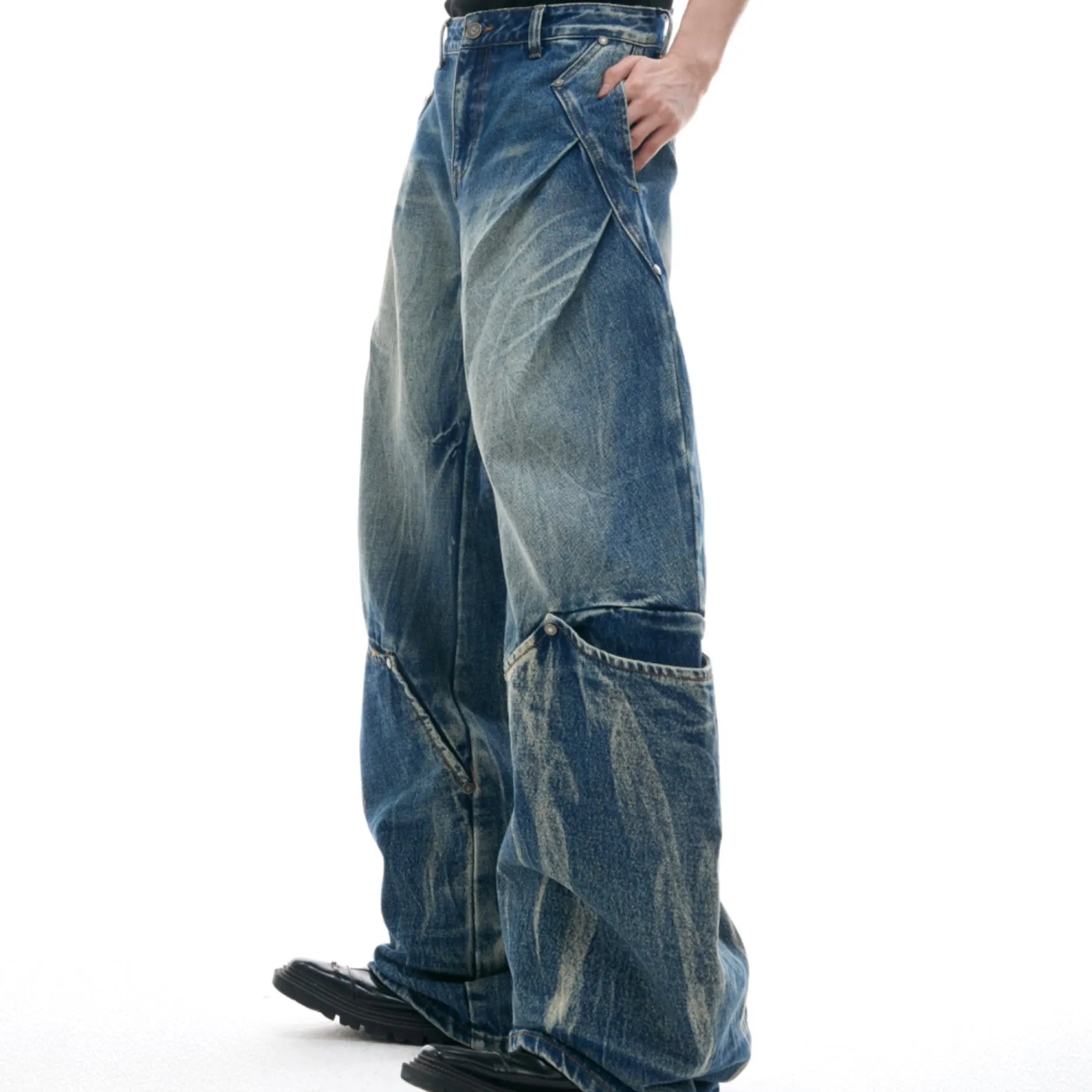 Men's verdant blue loose fit jeans with a washed burst pattern and curved knife leg style.