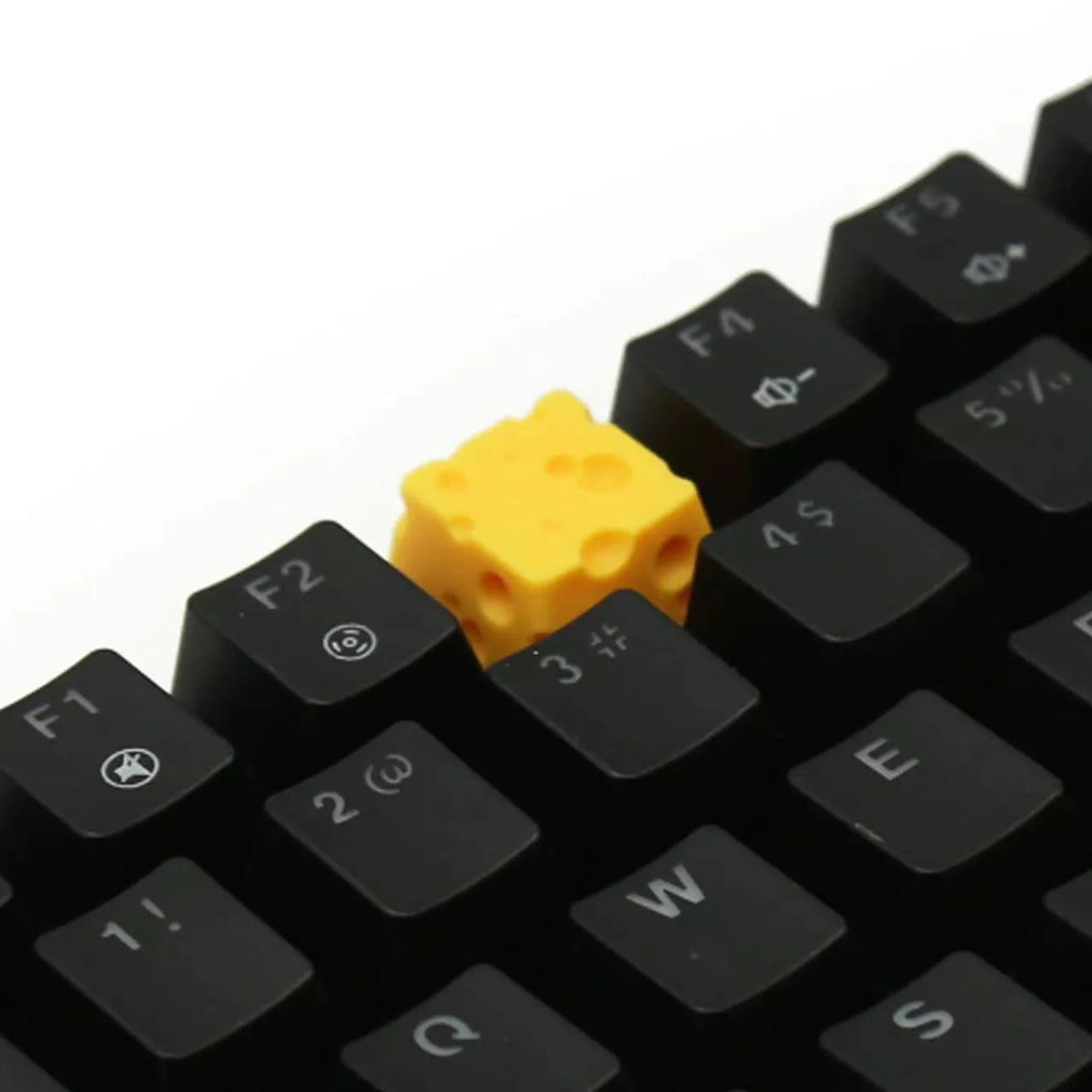 Yellow resin artisan keycap with a three-dimensional cheese design for mechanical keyboards.