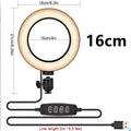 Adjustable live phone stand tripod extended to show height range with mobile phone attached.