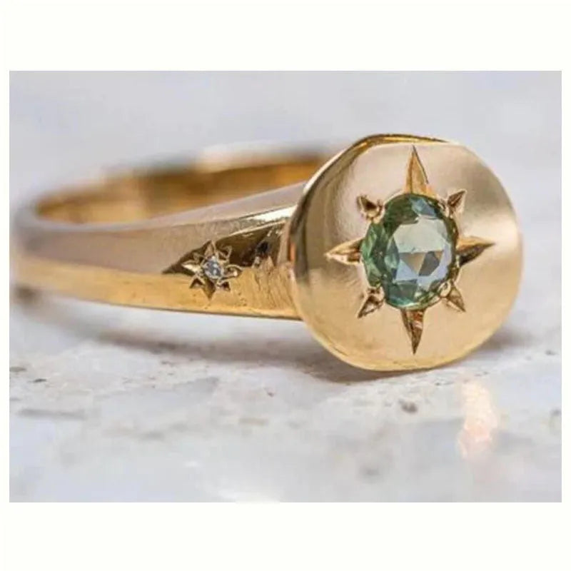 Gold-colour adjustable star ring with a central asterism zircon on a zinc alloy band.