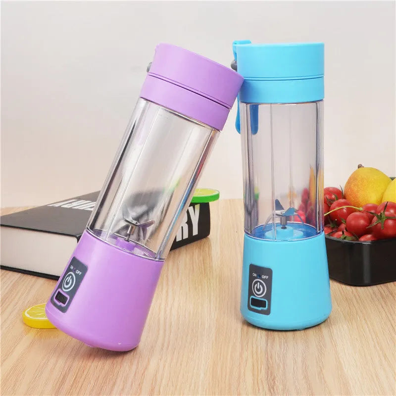 Mini USB-powered handheld fruit juicer with green plastic housing and a stainless steel blade.