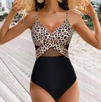 Stylish one-piece swimsuit with cross-strap design and mesh panels, available in a variety of vibrant colors