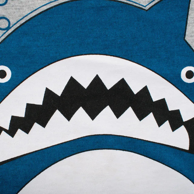 Grey cotton children's T-shirt laid flat, showing plain front and detailed size label.