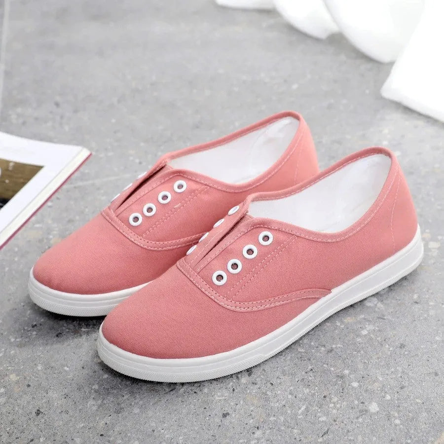Low-top canvas trainers in black, white, grey and pink colours with plastic sole