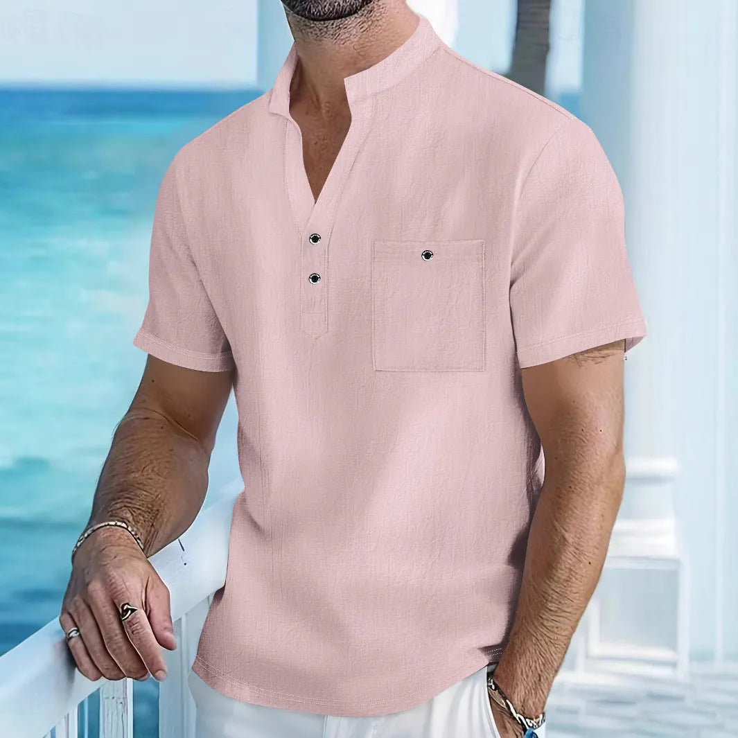 Man wearing a light-coloured linen blend stand collar t-shirt with short sleeves.