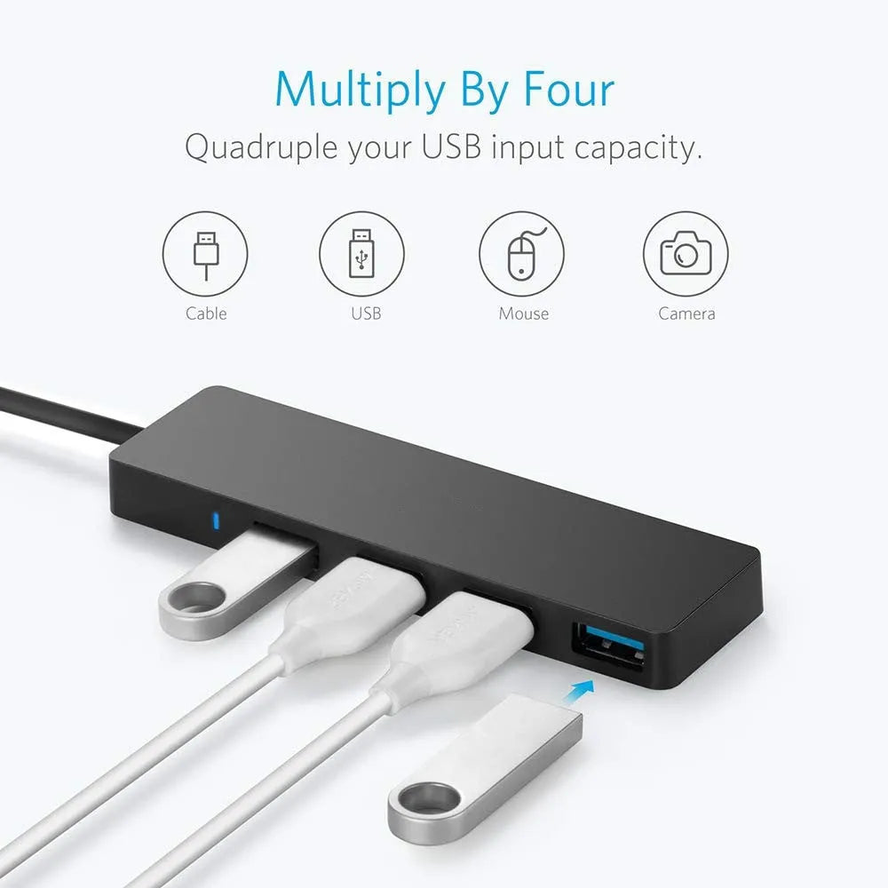 Black USB 3.0 hub with four ports, indicator lights, and a 30cm connecting cable on a desk.
