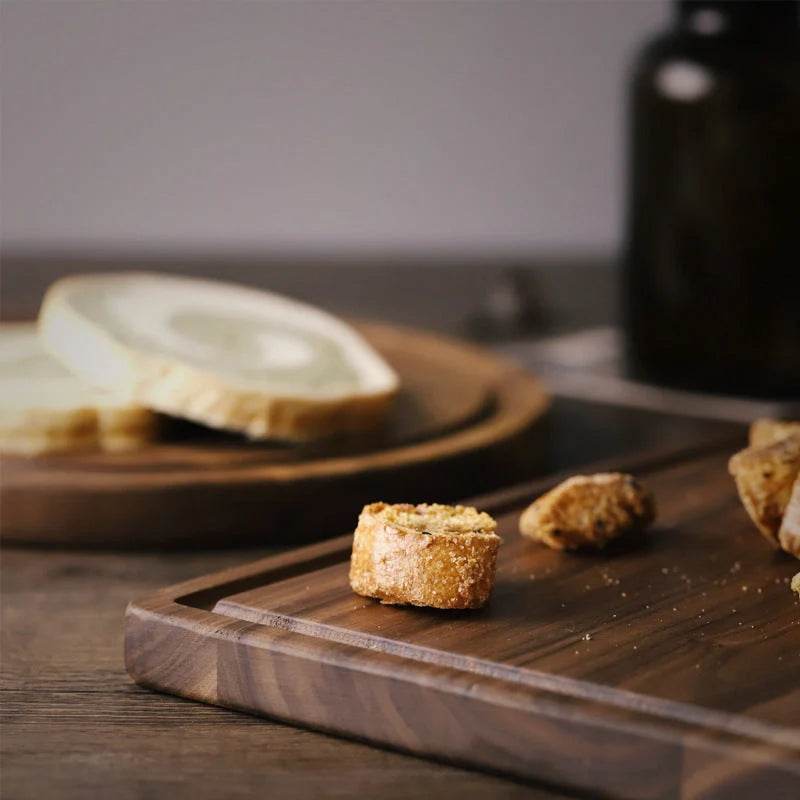 Black walnut wood cutting board with engraved handle and groove design for kitchen use