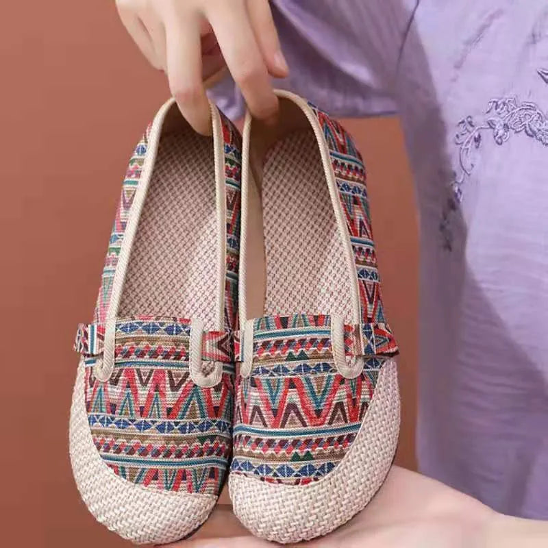 Women's flat heel ethnic cloth shoes in blue with colour stitching detail on a low-top, shallow mouth design.