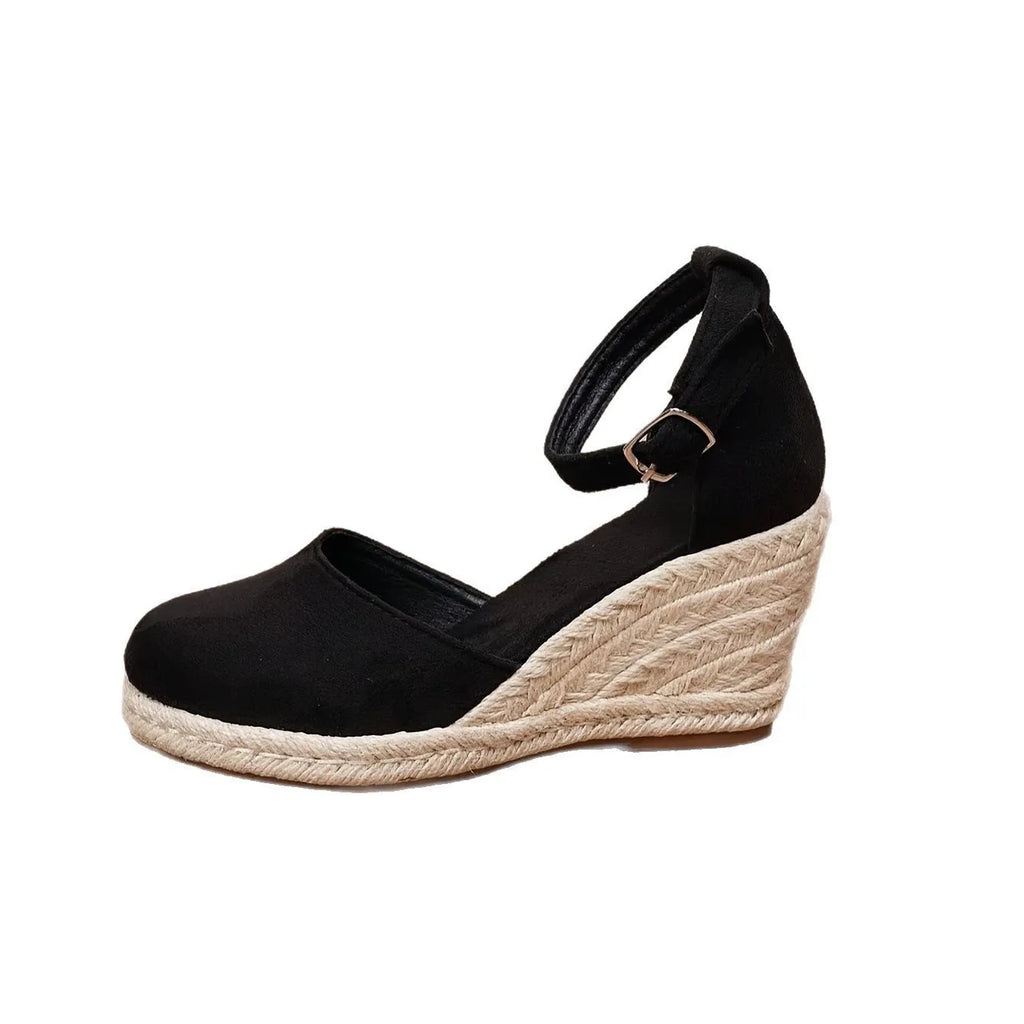 Women's apricot and black suede Roman-style wedge sandals with buckle and rubber sole.