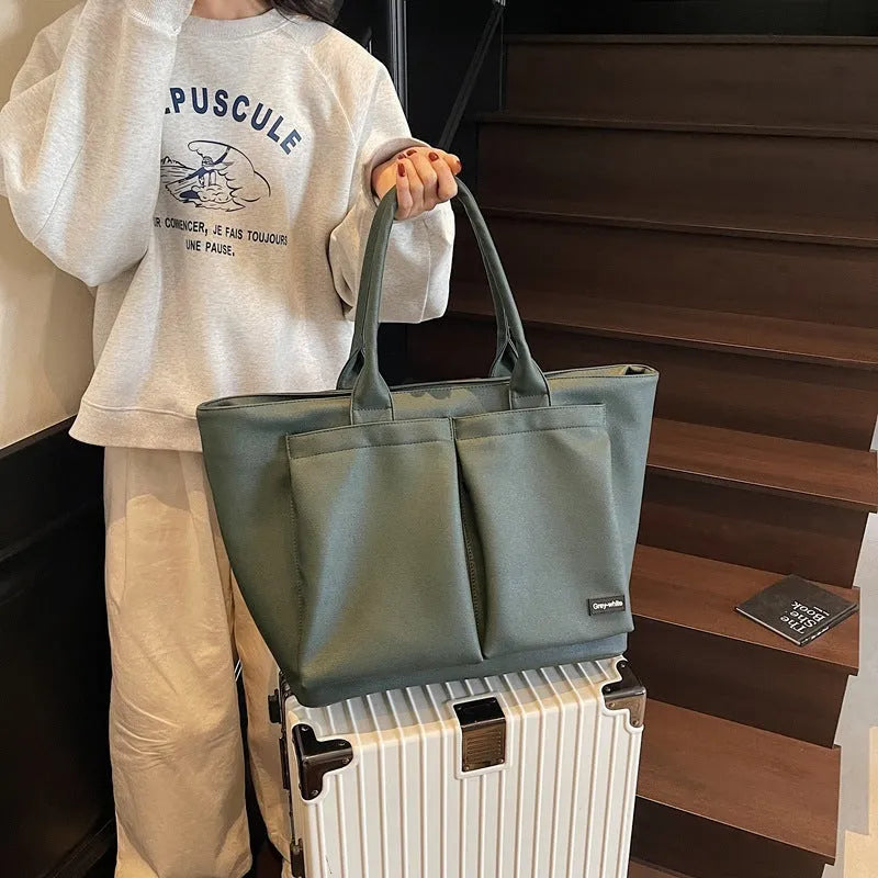 Lightweight sporty shoulder bag in PU material, shown in green colour