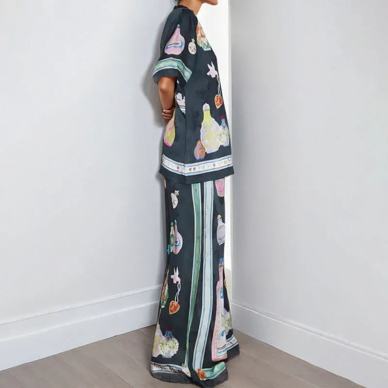 Black women's casual set with cartoon print, featuring a top with regular sleeves and matching trousers.