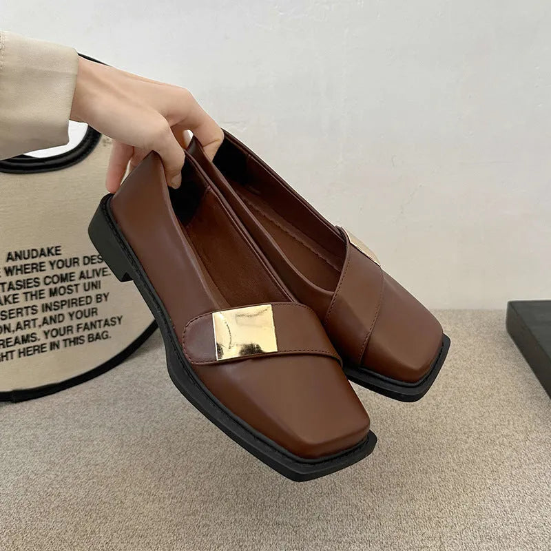 Beige women's square toe flat slip-on shoes with a metal buckle and low square heel.