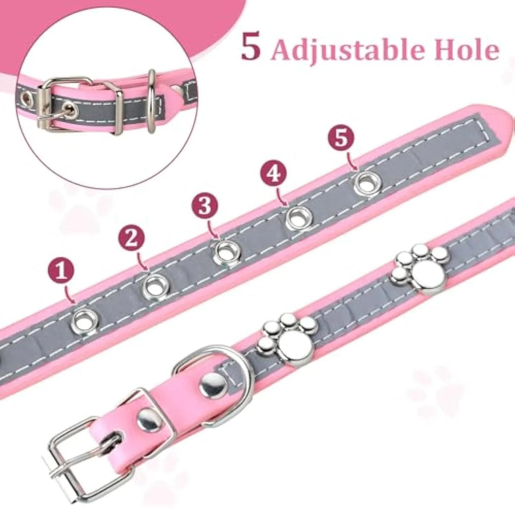 Reflective soft PU leather dog collar with metal buckle and decorative paw print rivets on a grey background.
