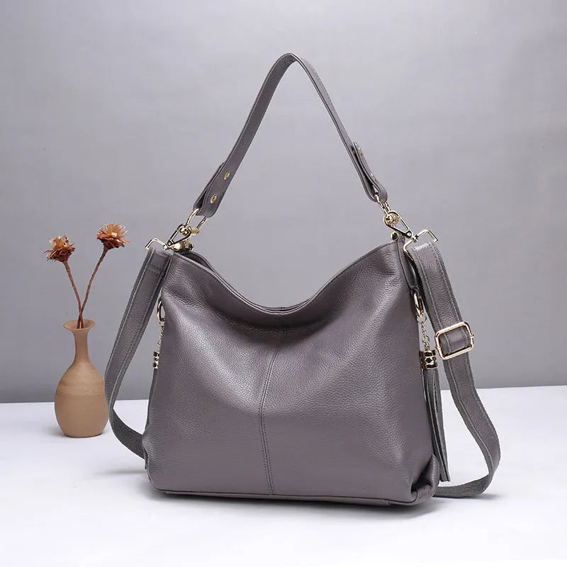 Genuine leather vertical square crossbody bag in black with multiple internal organiser pockets.