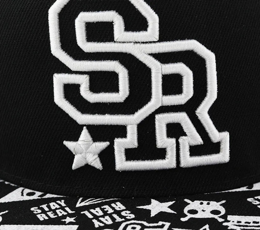Black and white cotton baseball cap with letter embroidery on the front, showing adjustable strap at back.
