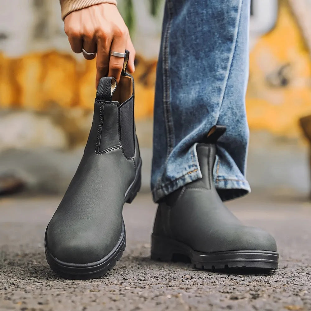 A pair of vintage-style brown unisex Chelsea boots with a round toe and low horseshoe heel.
