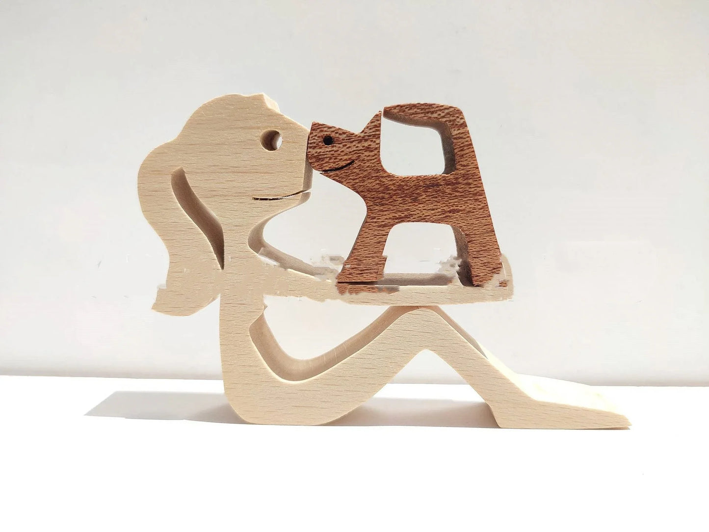 Handcrafted wooden dog sculpture featuring a man and his loyal canine companion