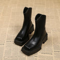 Women's black platform Martin boots with square toe and back zipper, showing 6-8cm heel