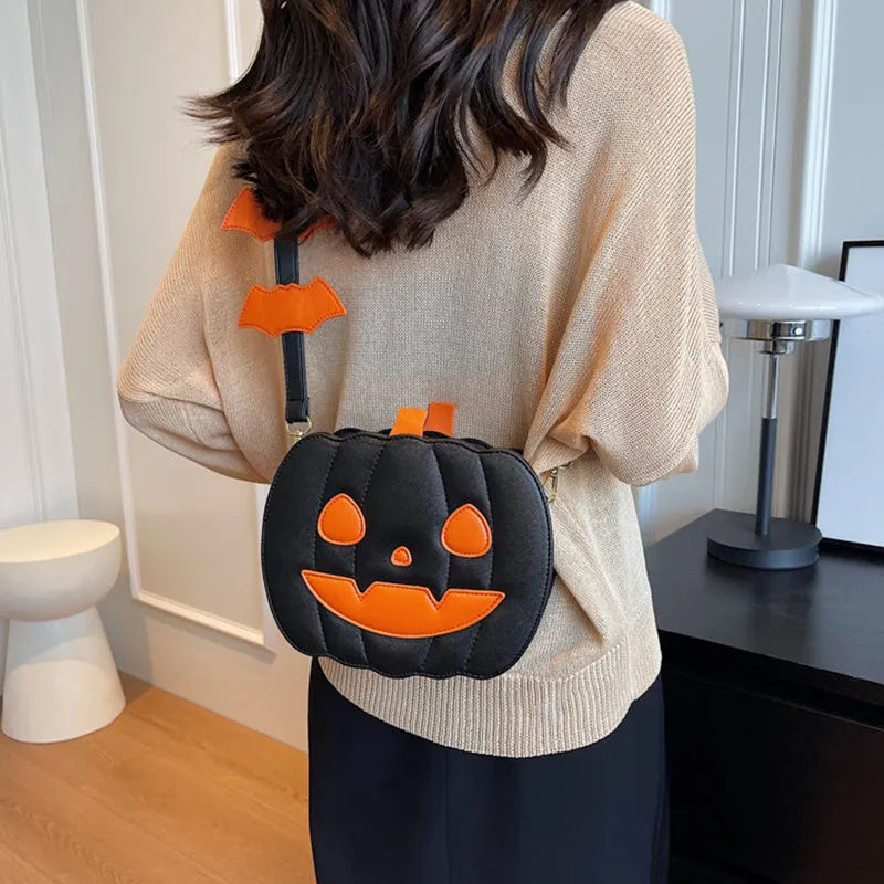 Horizontal view of a PU crossbody bag with pumpkin and bat cartoon design in orange colour option.