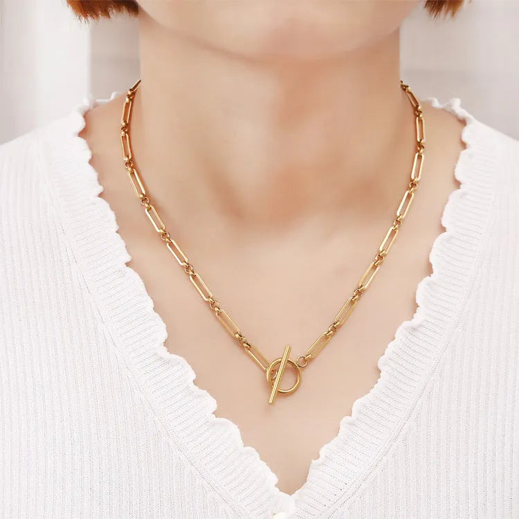 Stainless steel Chopin chain necklace and bracelet set in gold finish on white background