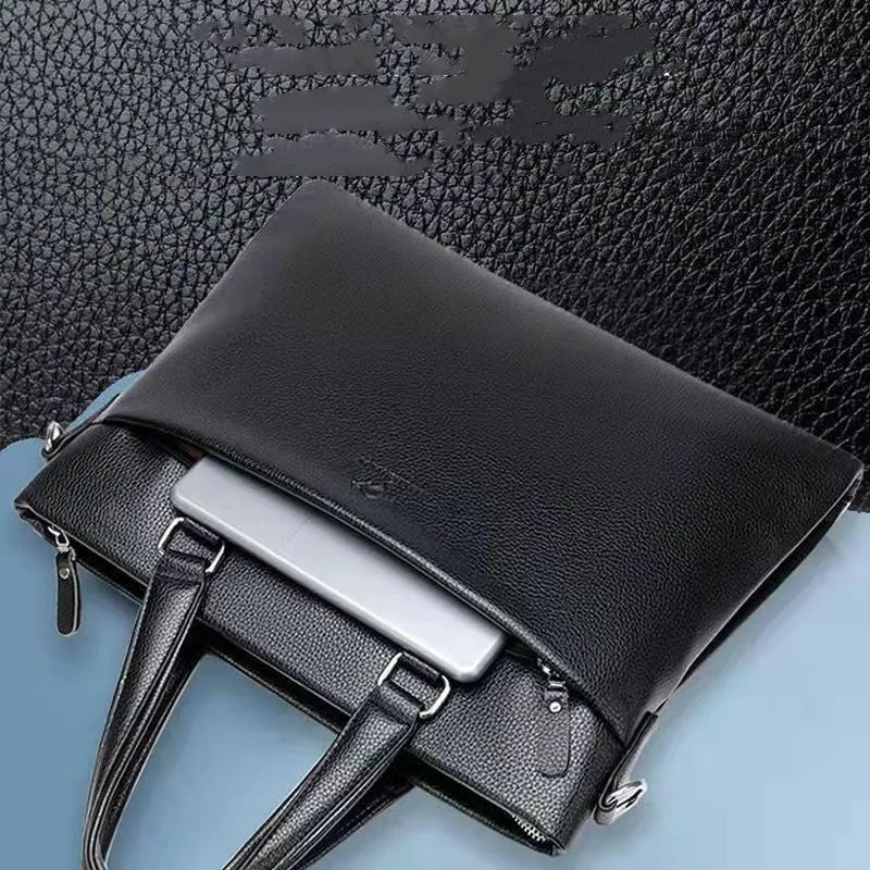 Men's black PU leather shoulder messenger bag with splicing detail on a table