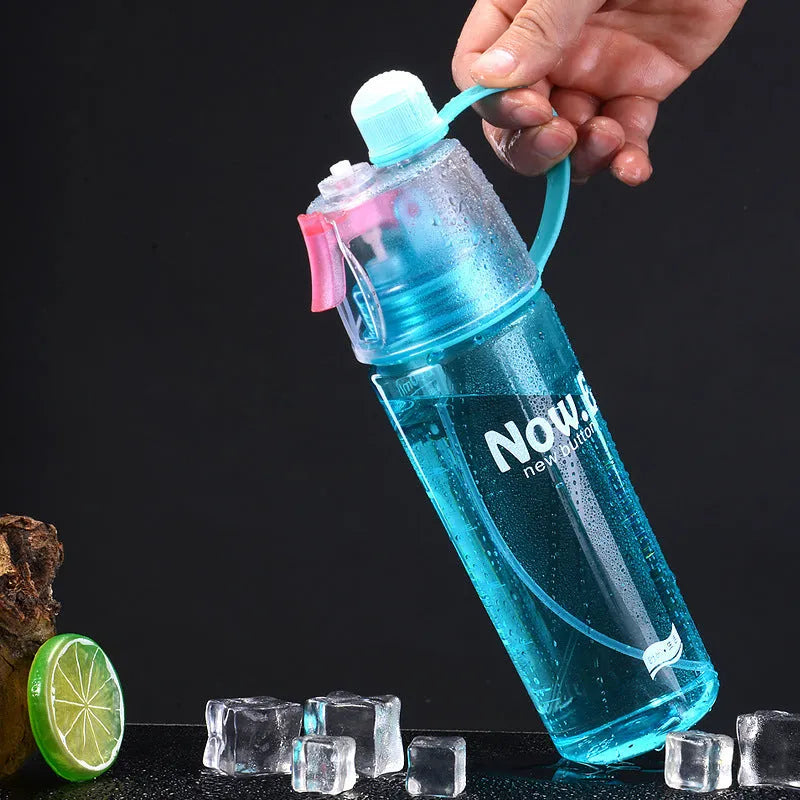 Green portable outdoor mist spray cup with handle, leakproof pad, and visible water level scale.