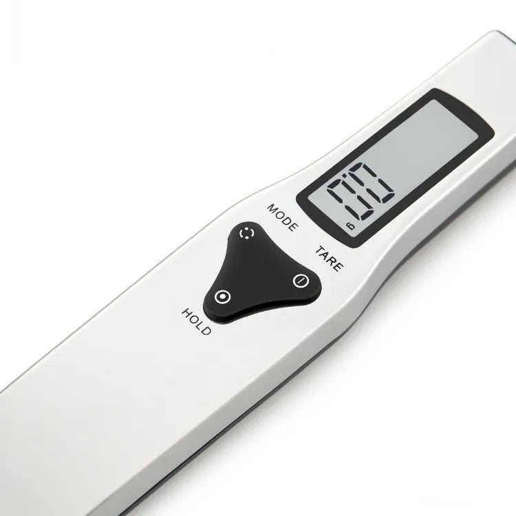 Smart digital kitchen measuring spoon with backlit LCD display showing weight and volume measurements.