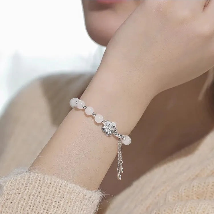 New Chinese style beaded bracelet with floral resin charms showing camellia, lotus and peach blossom designs