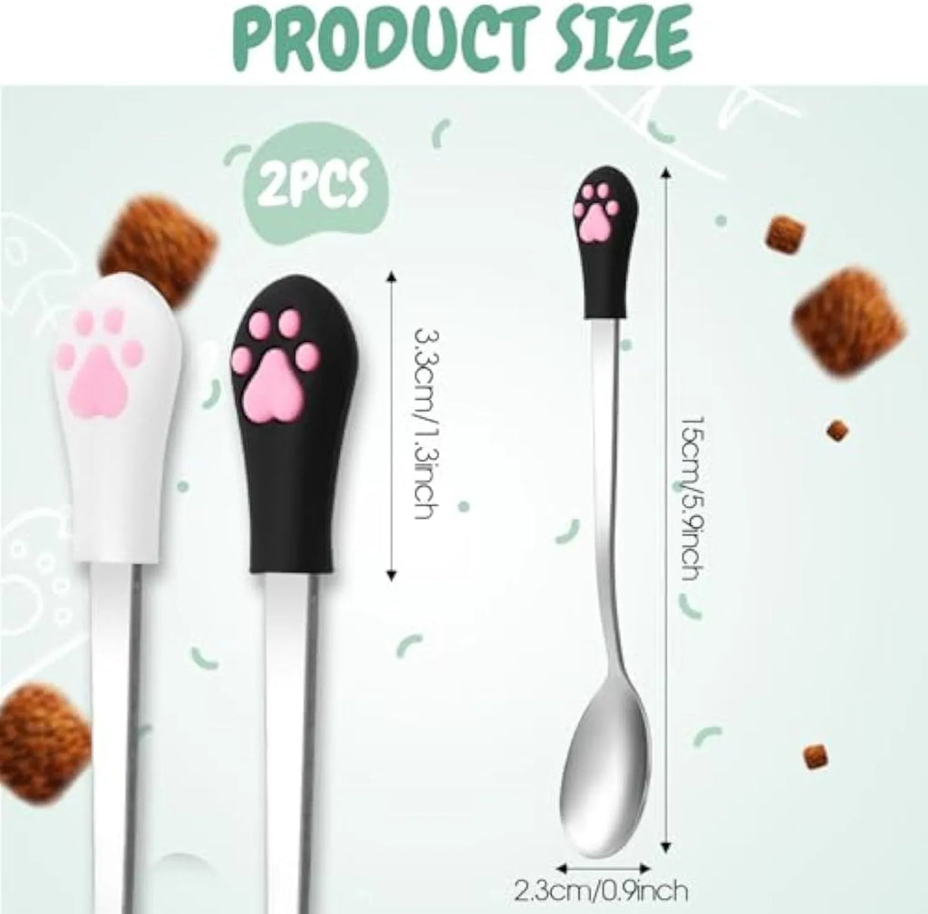 Two stainless steel pet food spoons with white and black silicone handles featuring a cat paw print design.
