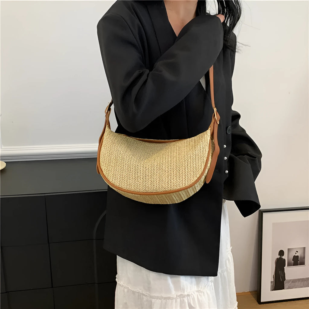 Women's woven straw crossbody bag showing textured surface and internal phone pocket