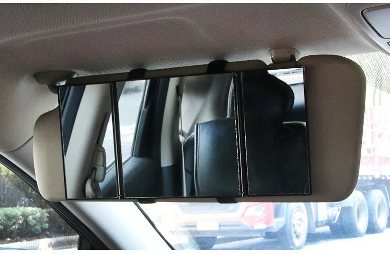 Silver car folding grooming mirror shown opened and closed on a car dashboard.