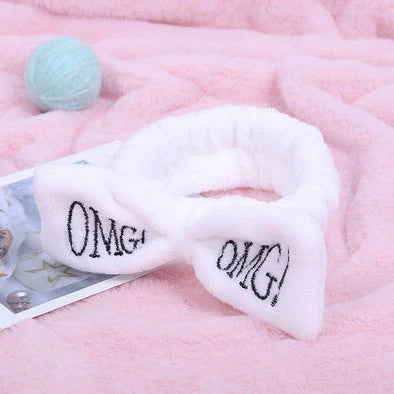 Coral velvet butterfly end hair band in pink with text styling, showing butterfly ends and cloth material