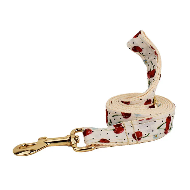 Red cherry printed dog collar and leash set with bow accessory and light gold release buckle