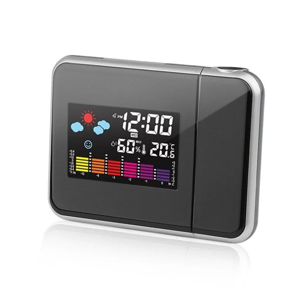 Black digital projection alarm clock on a surface, showing its compact plastic design.