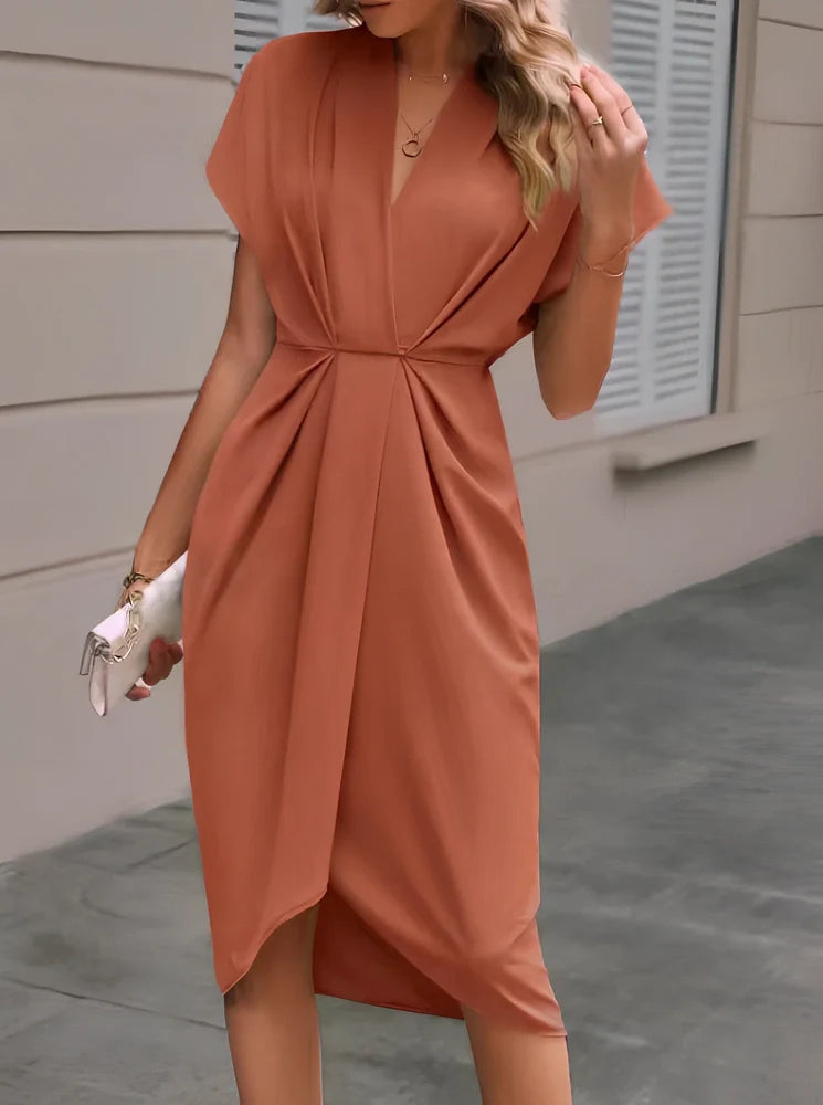 Black V-neck batwing sleeve polyester dress with pleated A-line skirt, mid-length 94cm in size M, showing shrug sleeves and solid colour fabric