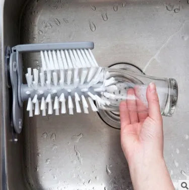 Grey double-headed cup cleaning brush with wall-mounted suction cups for kitchen use