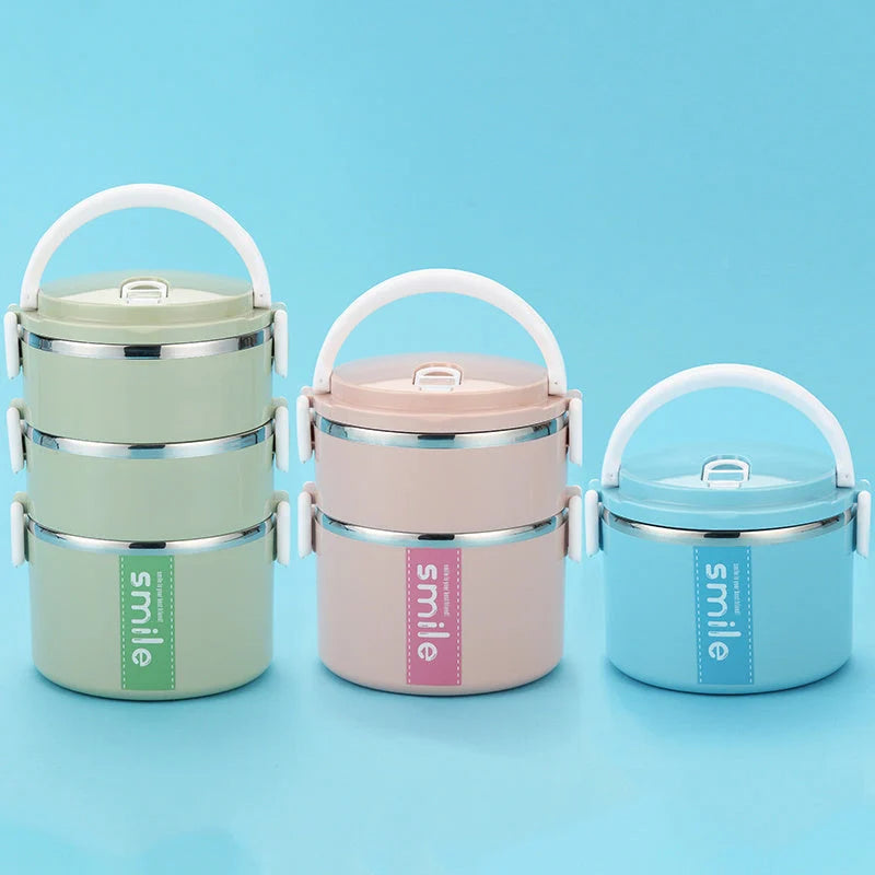 Stainless steel lunch box with built-in spoon, leak-proof design, in green, pink, and blue