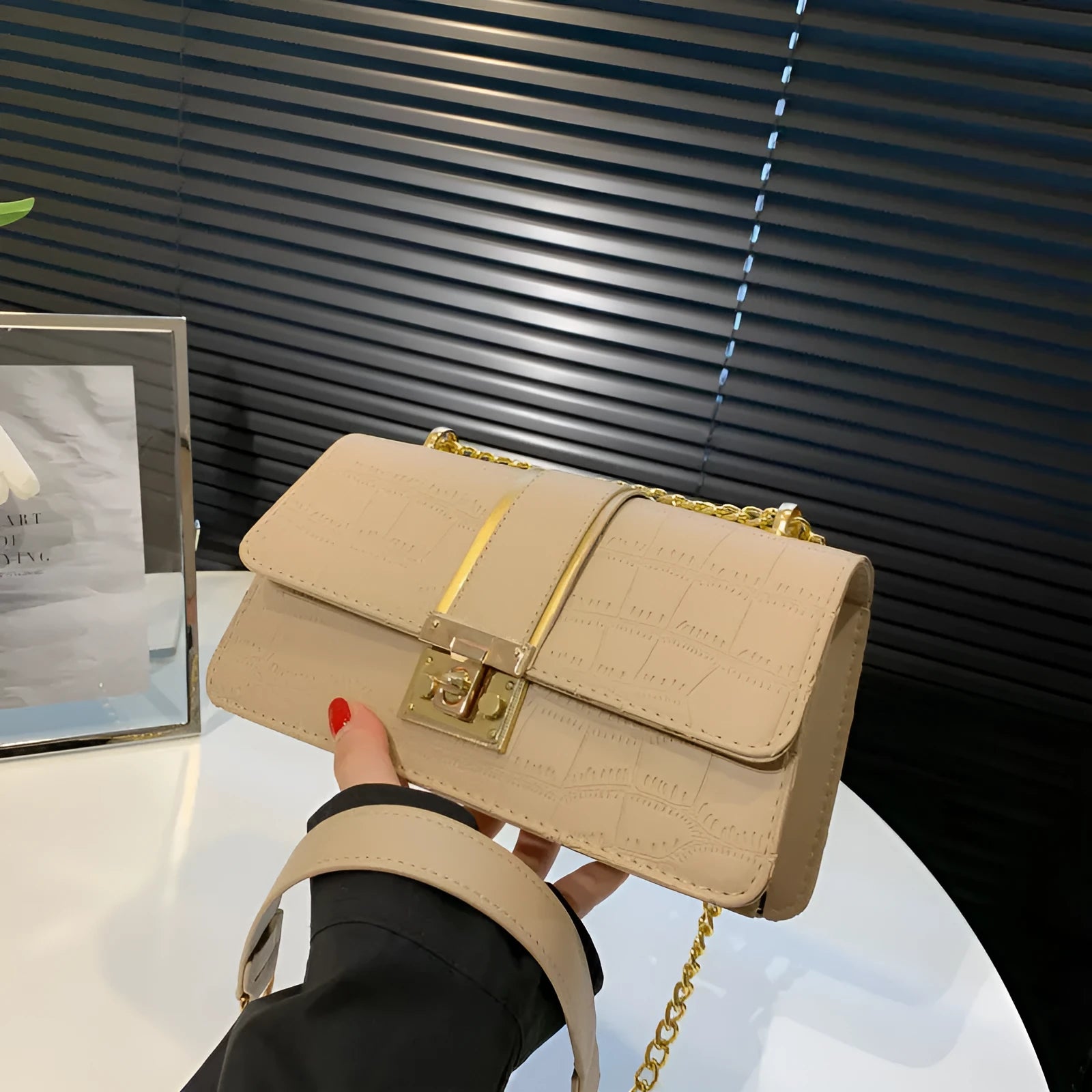 Horizontal square PU shoulder bag in khaki with contrast stitching and chain strap on a white background