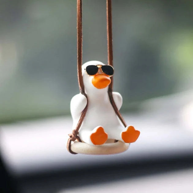 Gypsum duck ornament with swing tire design measuring 6x5x6cm for decorative displays