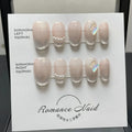 Women's handmade false nails with simple blush armour design in short length.